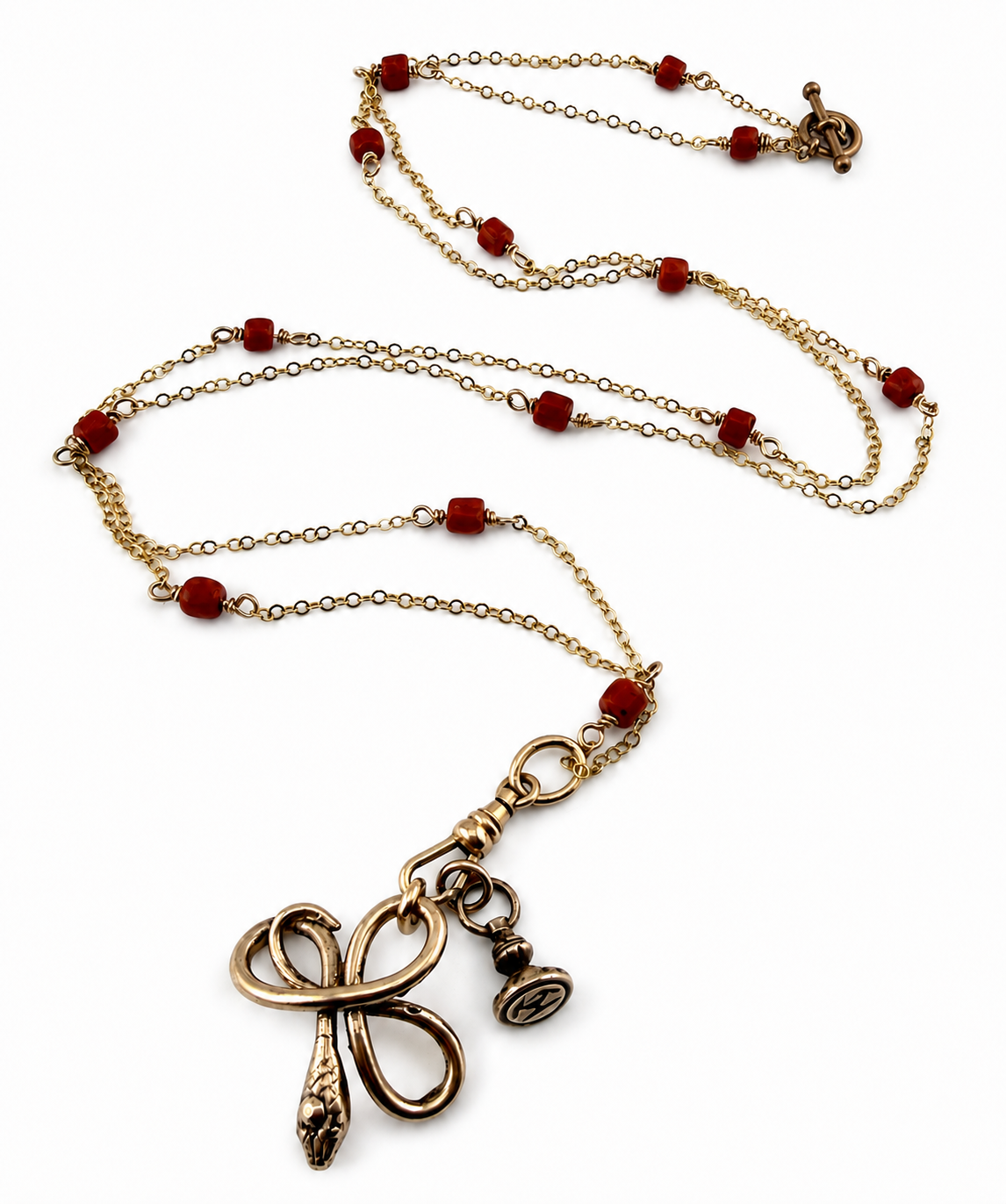 
                  
                    SERPENT Charm Necklace in Bronze with Mediterranean Coral
                  
                