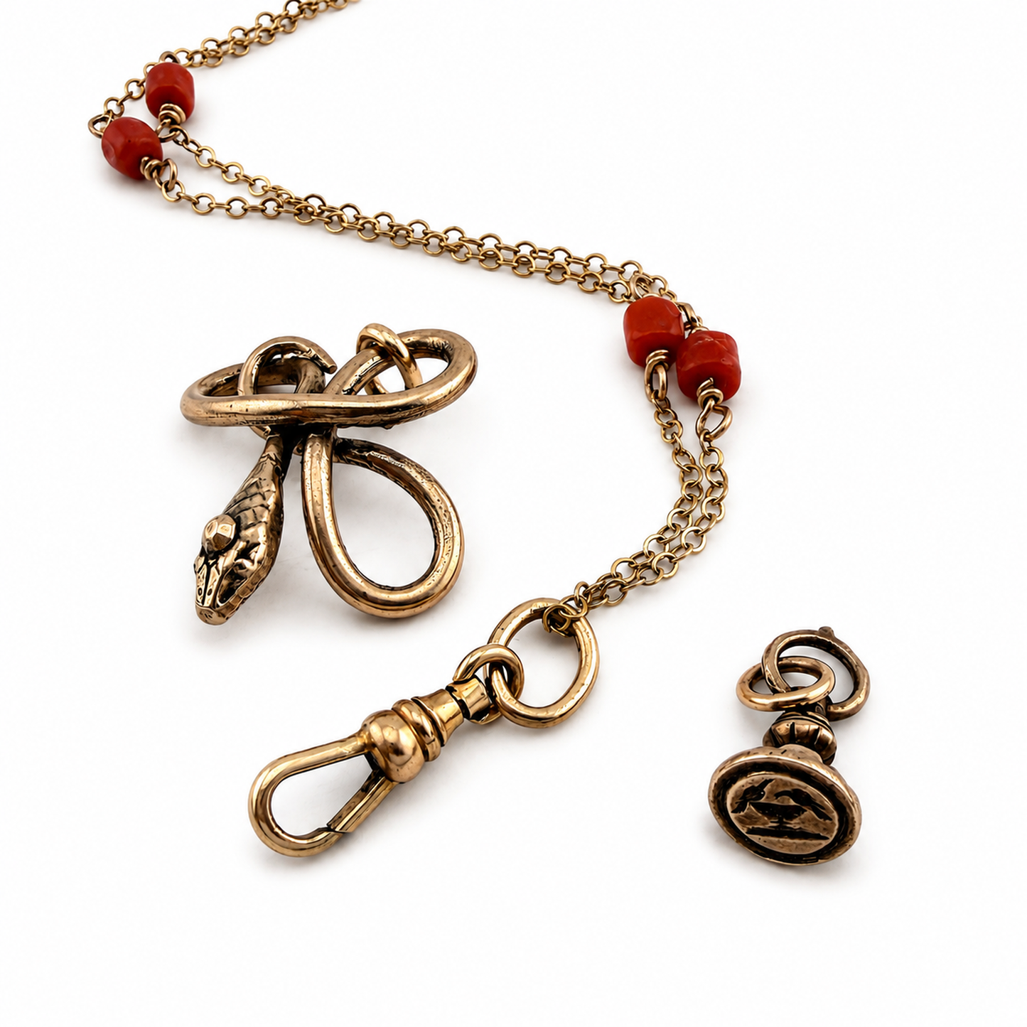 
                  
                    SERPENT Charm Necklace in Bronze with Mediterranean Coral
                  
                